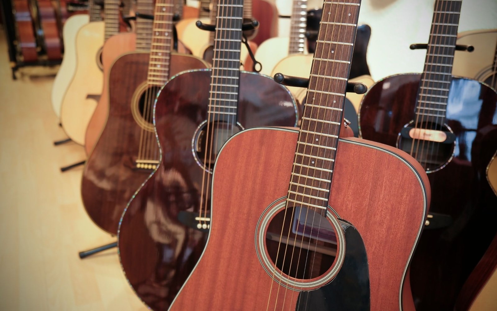 A CITES certificate laid flat beside an Indian rosewood fretboard blank on a workshop bench, grain and certificate text both legible