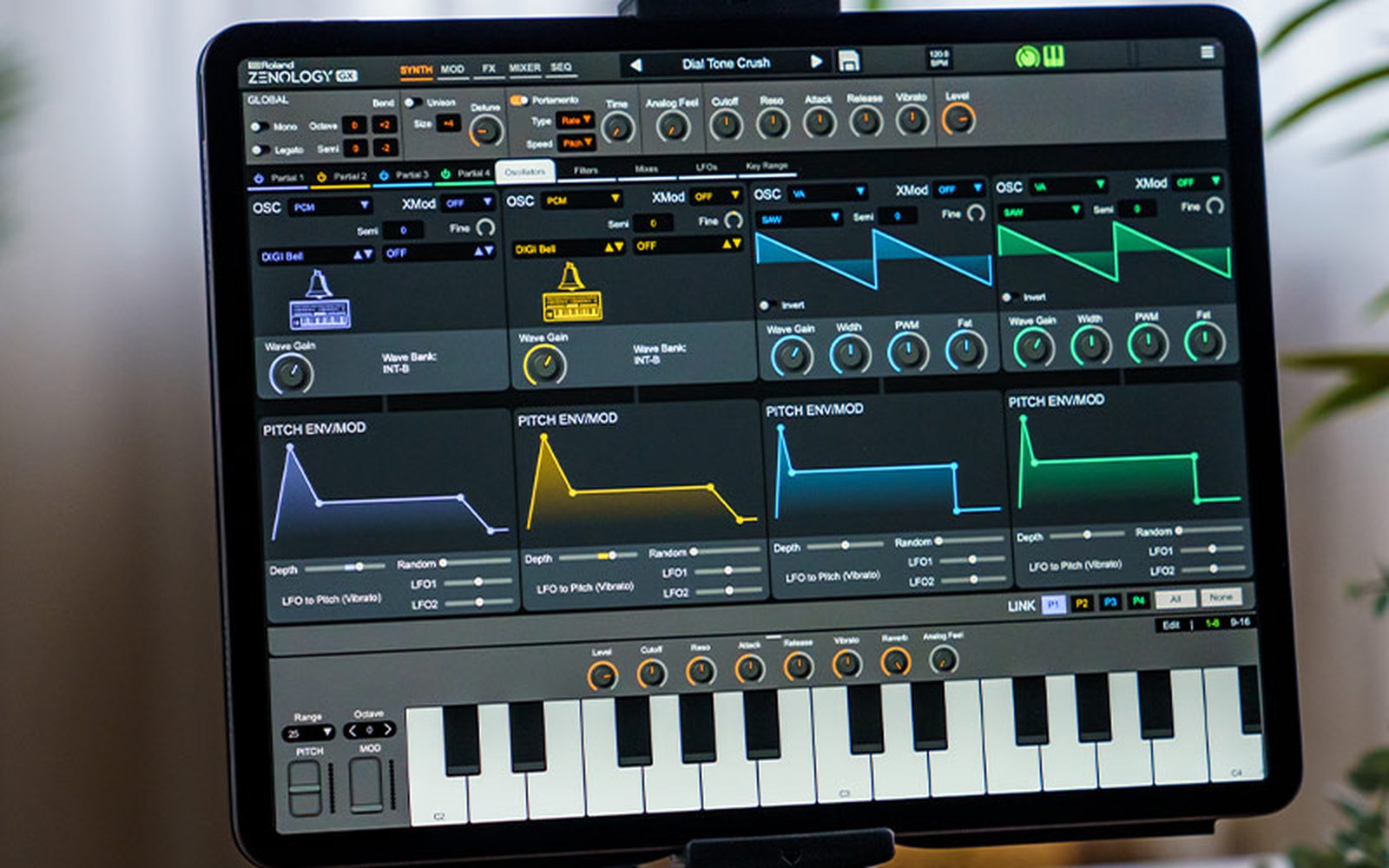 A tablet displays the Roland Zenology synth app with oscillator controls and a keyboard interface